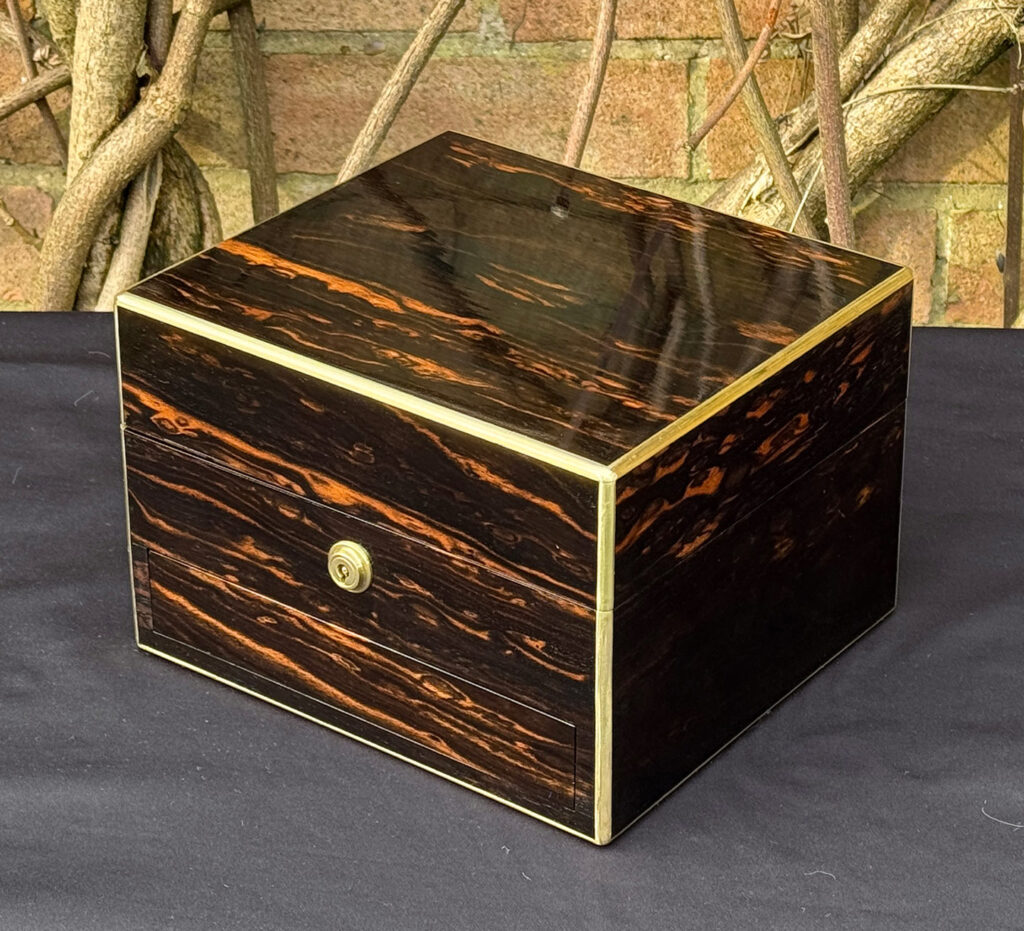 Front right view of a rare miniature antique jewellery box in coromandel, by George Betjemann & Sons.