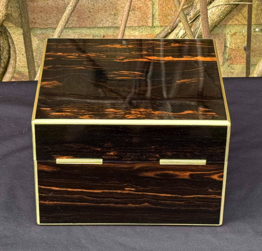 Rear view of a rare miniature antique jewellery box in coromandel, by George Betjemann & Sons.