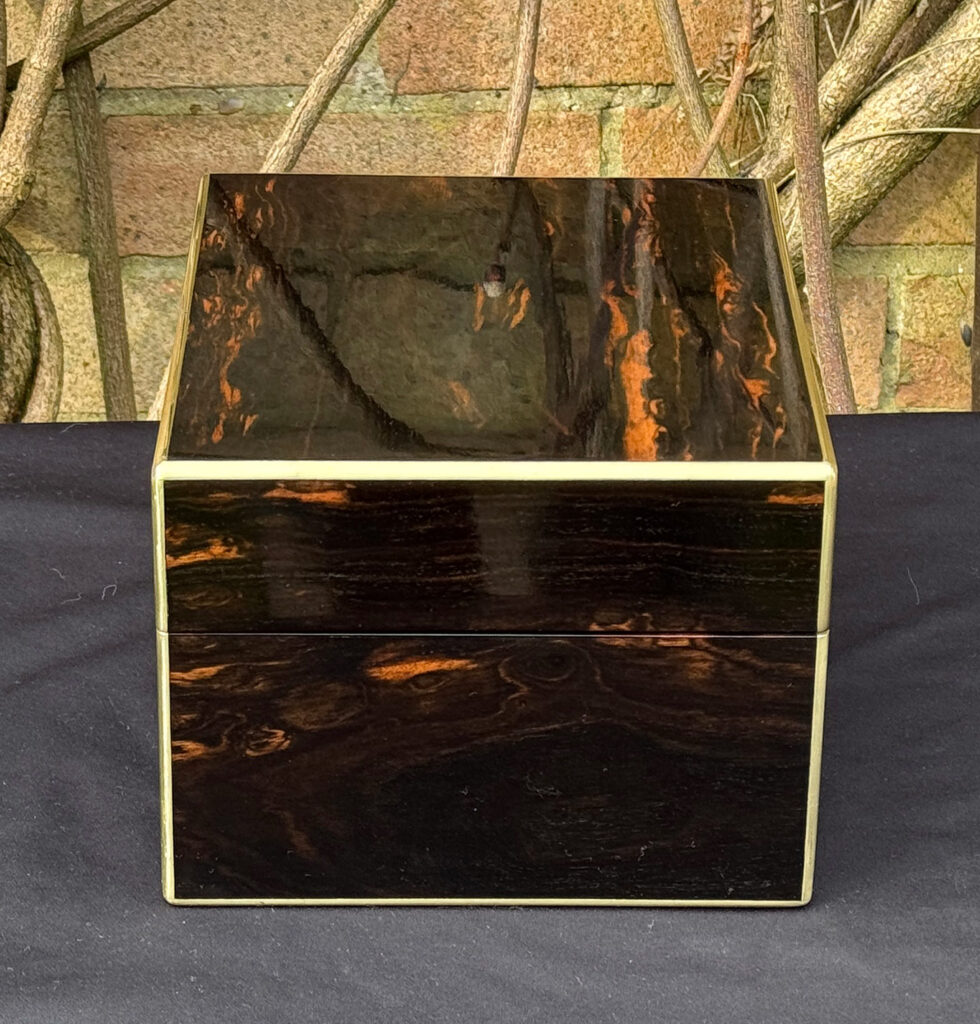 Left side view of a rare miniature antique jewellery box in coromandel, by George Betjemann & Sons.