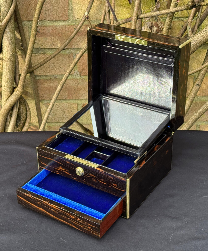 Front right interior view of a rare miniature antique jewellery box in coromandel, by George Betjemann & Sons, with mirror panel dropped forward.