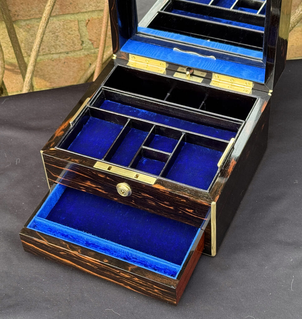 Closer interior view of a rare miniature antique jewellery box in coromandel, by George Betjemann & Sons.