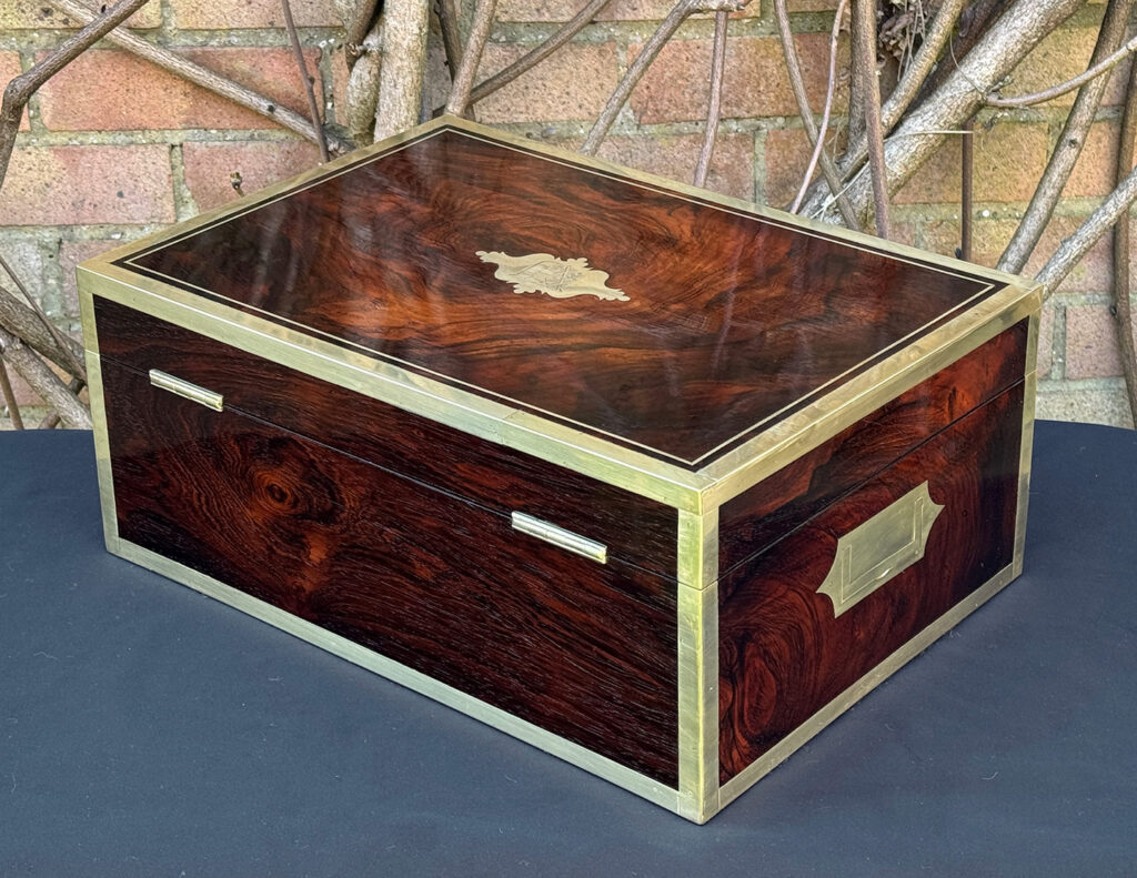 Rear left view of a large antique jewellery and writing Box in rosewood with naval heritage, attributed to Edwards.