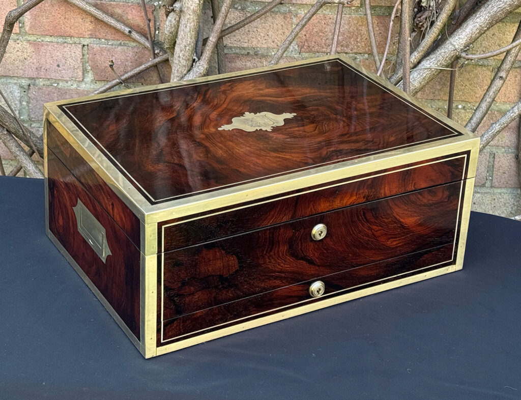 Front left view of a large antique jewellery and writing Box in rosewood with naval heritage, attributed to Edwards.