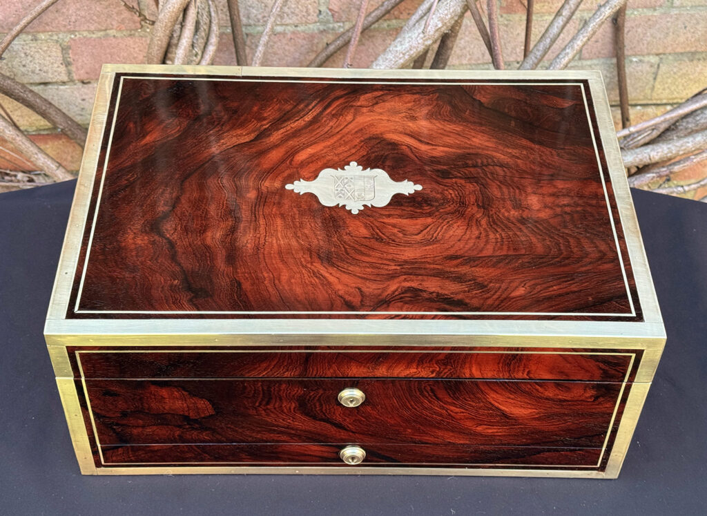 Overhead view of a large antique jewellery and writing Box in rosewood with naval heritage, attributed to Edwards.