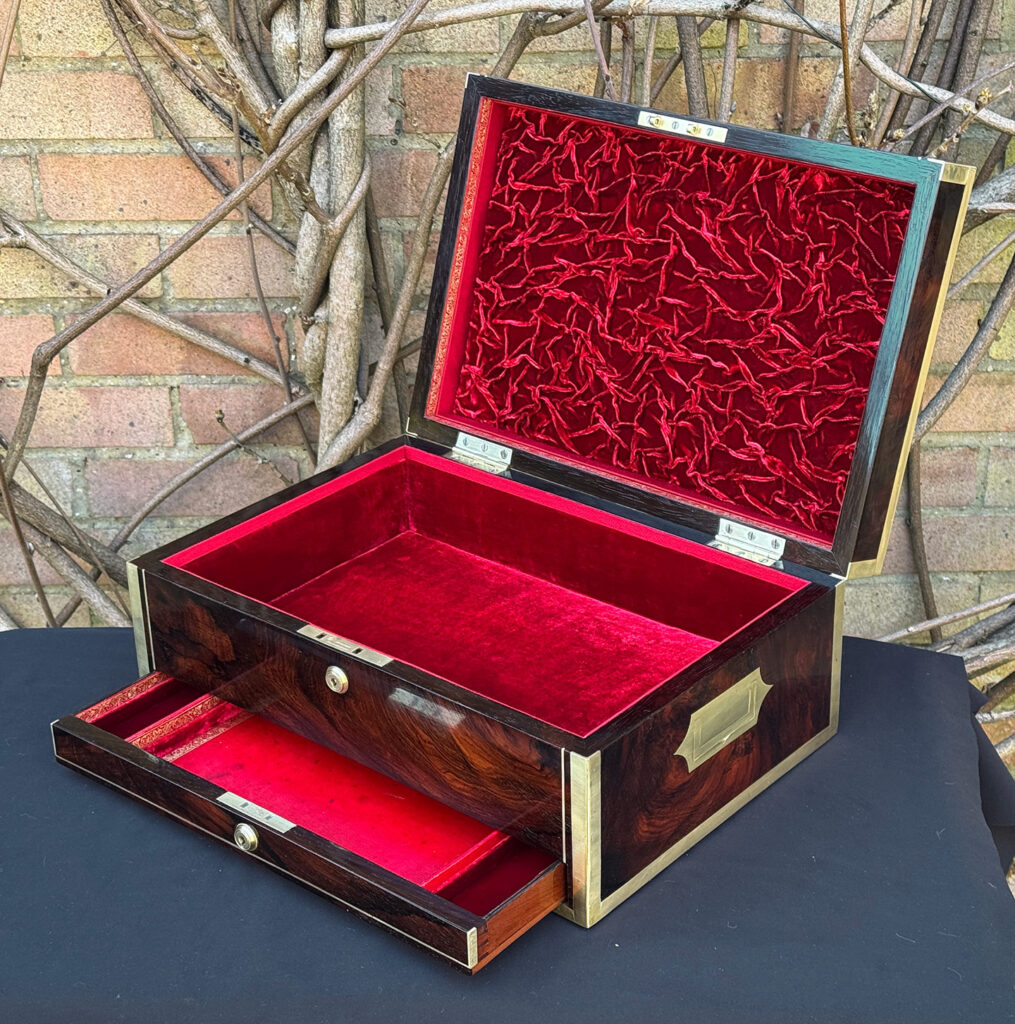 Front right interior view of a large antique jewellery and writing Box in rosewood with naval heritage, attributed to Edwards, with lower drawer opened.