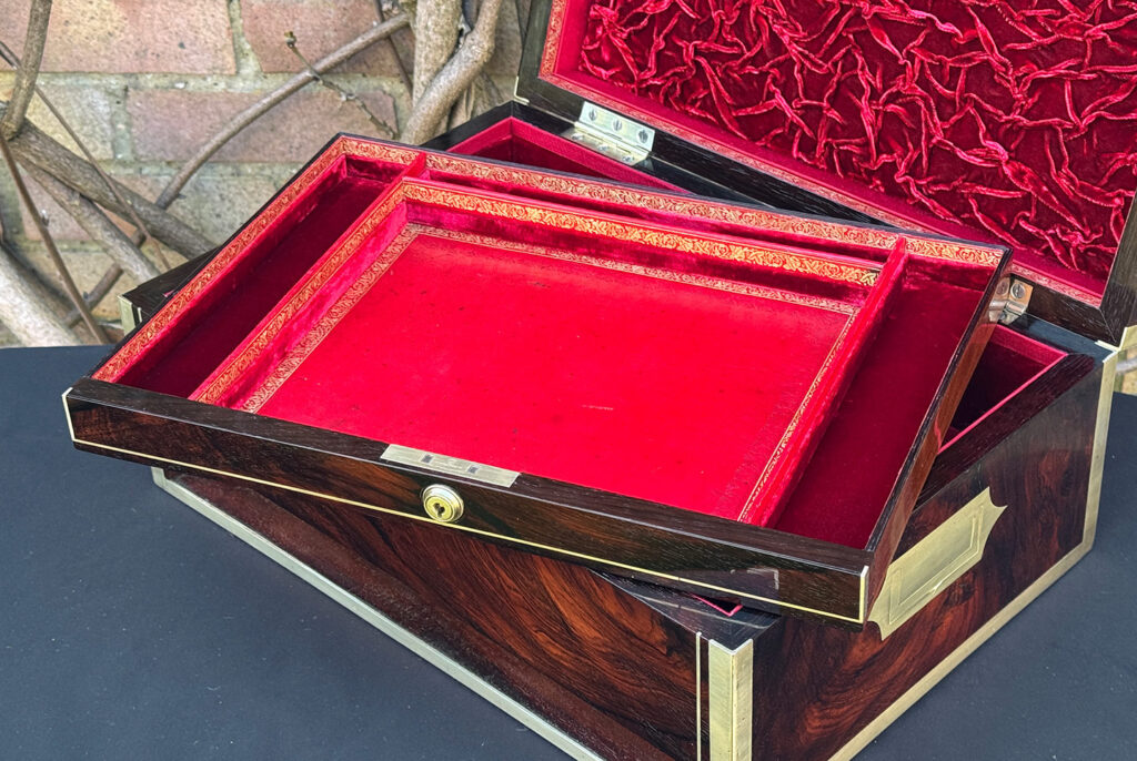 Closer interior view of a large antique jewellery and writing Box in rosewood with naval heritage, attributed to Edwards, with lower drawer featured.
