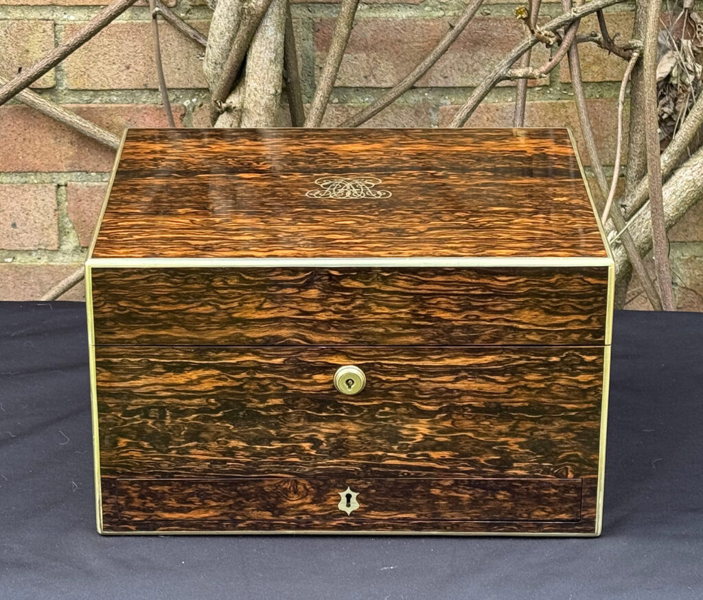 Front view of an antique jewellery box in coromandel by Halstaff & Hannaford.