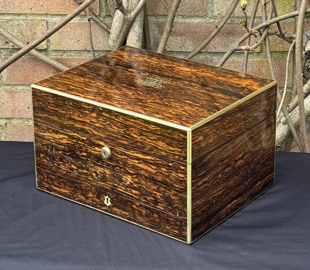 Front right view of an antique jewellery box in coromandel by Halstaff & Hannaford.
