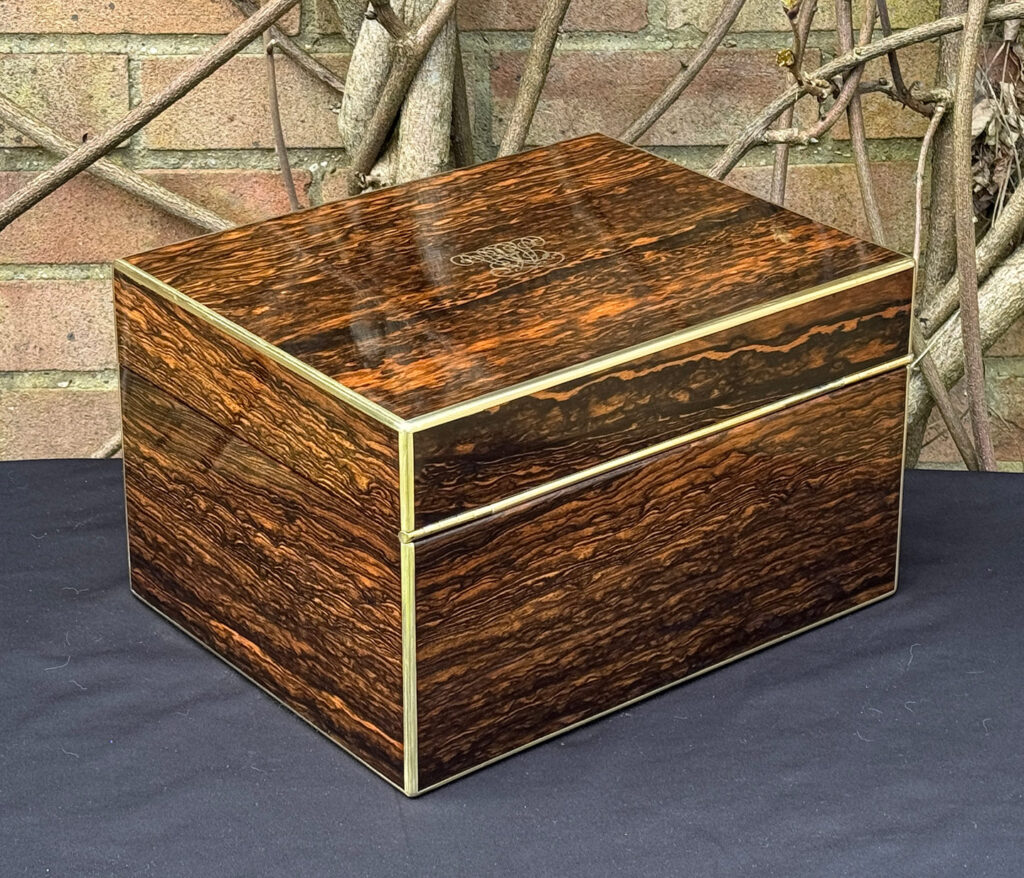 Rear right view of an antique jewellery box in coromandel by Halstaff & Hannaford.