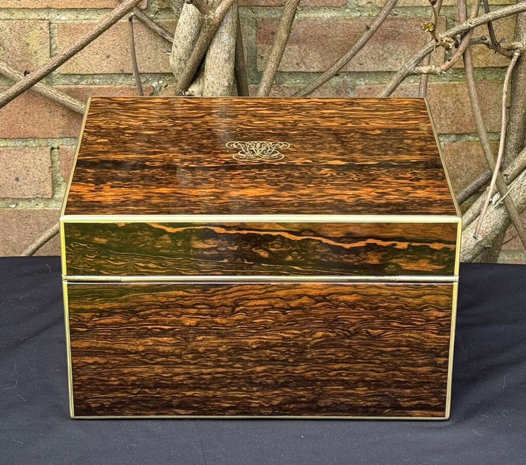 Rear view of an antique jewellery box in coromandel by Halstaff & Hannaford.