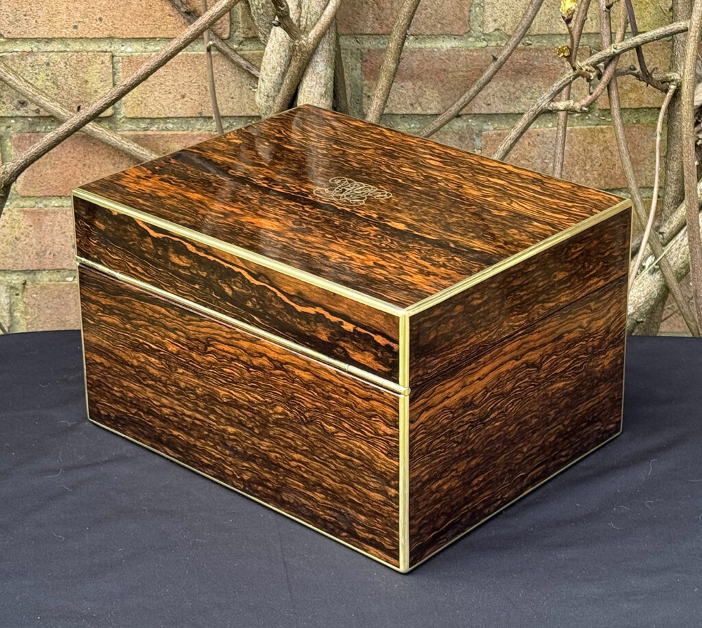 Rear left view of an antique jewellery box in coromandel by Halstaff & Hannaford.