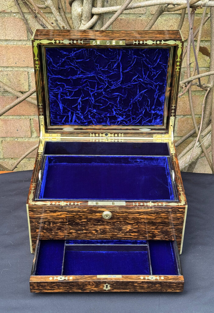 Front interior view of an antique jewellery box in coromandel by Halstaff & Hannaford.