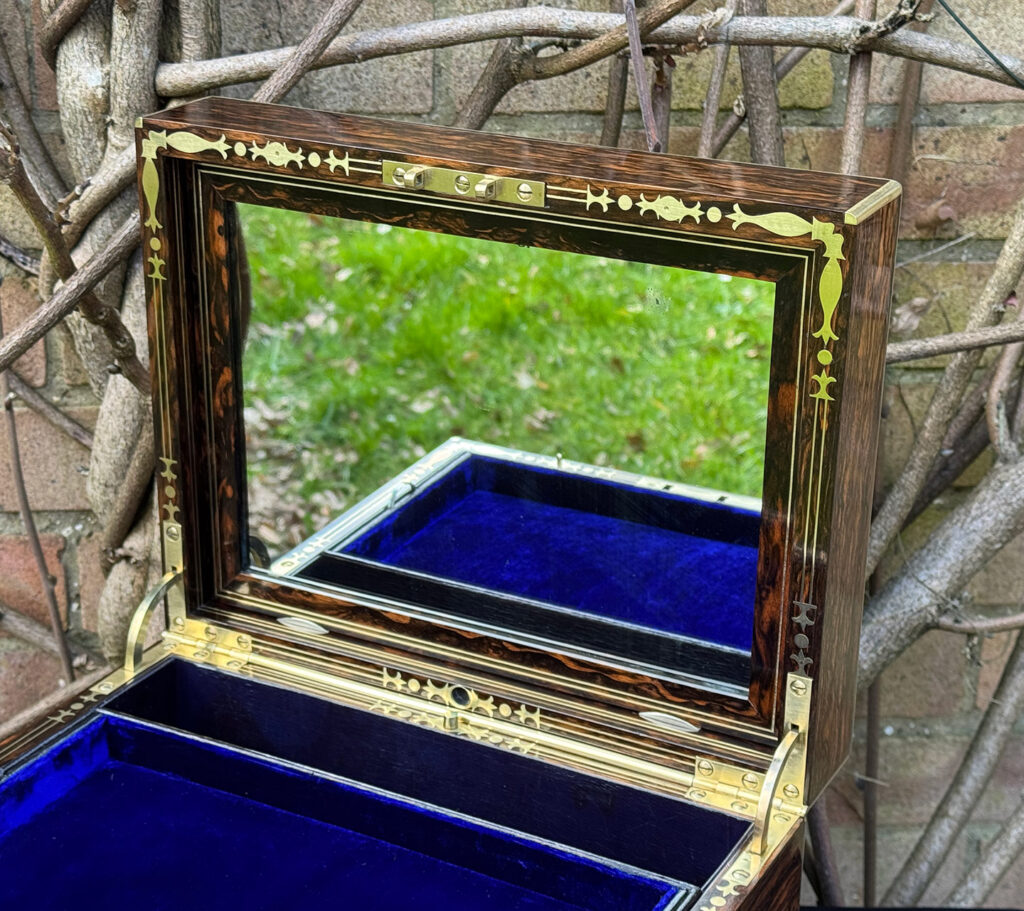 Closer view of the mirror frame from an antique jewellery box in coromandel by Halstaff & Hannaford.