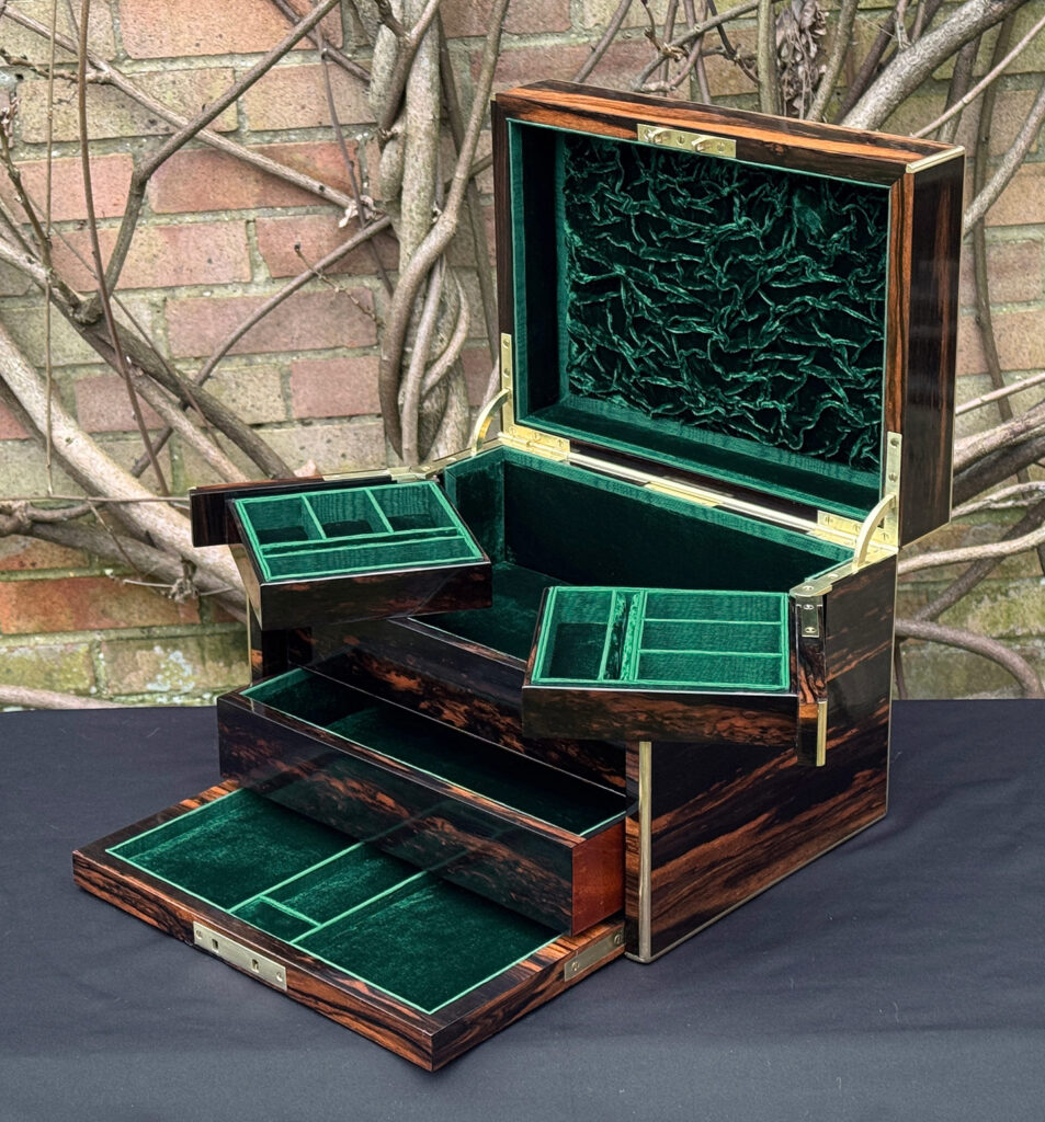 Front right interior view of an antique jewellery box in calamander with trays semi-opened - A wedding gift to the Duchess of St. Albans.