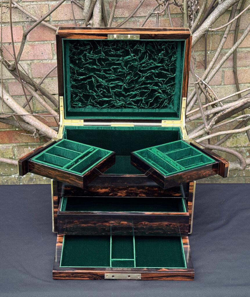 Front interior view of an antique jewellery box in calamander with trays semi-opened - A wedding gift to the Duchess of St. Albans.