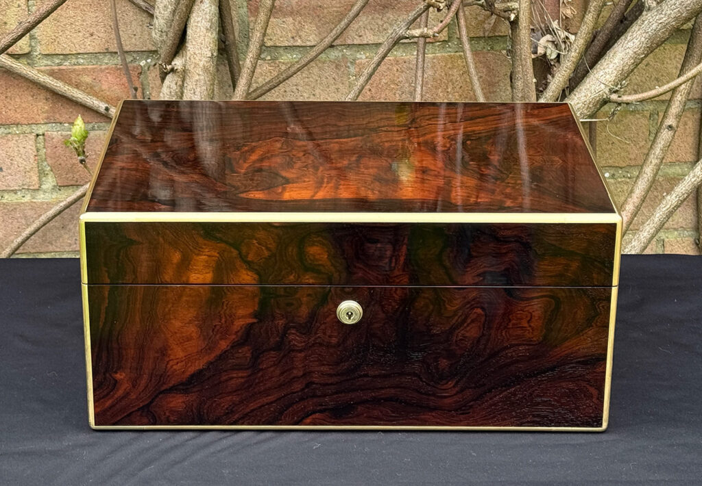 Lower front view of a large antique document & jewellery box in rosewood by Edwards.