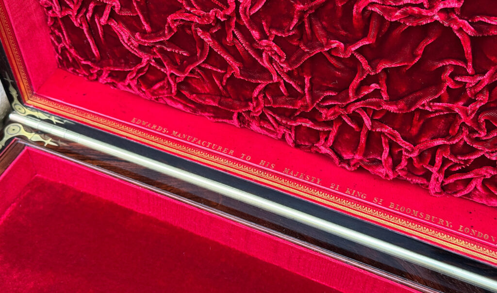 Close up view of the Edwards manufacturer's mark in gold tooling.