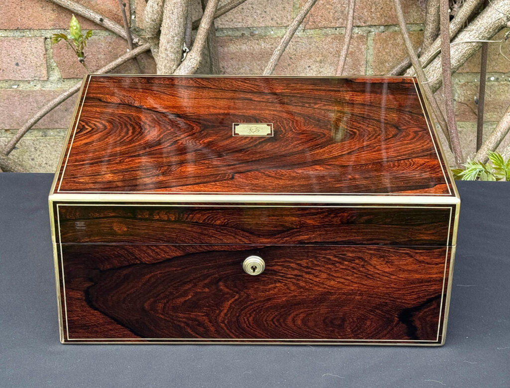 Front view of an antique jewellery box in rosewood, by Edwards.