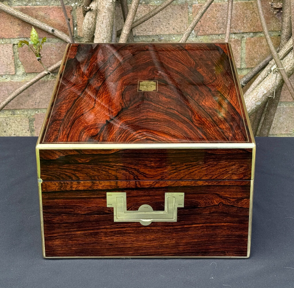 Left side view of an antique jewellery box in rosewood, by Edwards.