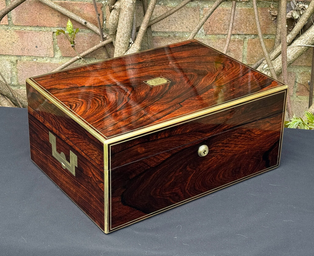 Front left view of an antique jewellery box in rosewood, by Edwards.