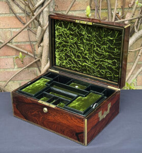 Front right interior view of an antique jewellery box in rosewood, by Edwards.