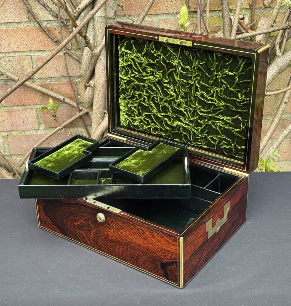 Front right interior view of an antique jewellery box in rosewood, by Edwards, with top tray removed.