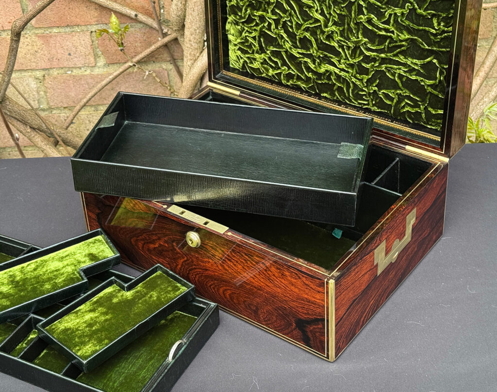 Front right interior view of an antique jewellery box in rosewood, by Edwards, with lower tray removed.