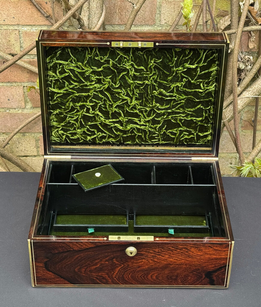 Front right interior view of an antique jewellery box in rosewood, by Edwards, with both trays removed.