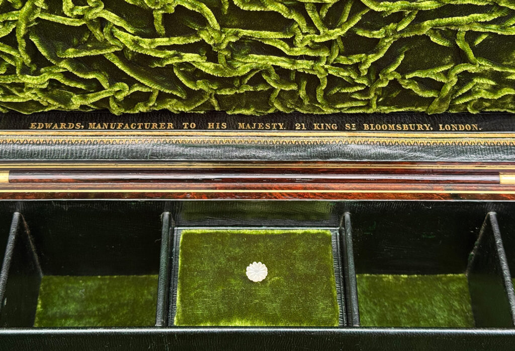 Close up view of the Edwards manufacturer mark in gold tooling.