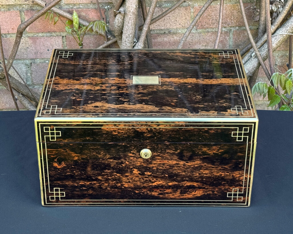 Front view of an antique jewellery box in coromandel, by William Lund.