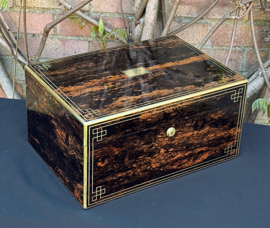 Front left view of an antique jewellery box in coromandel, by William Lund.