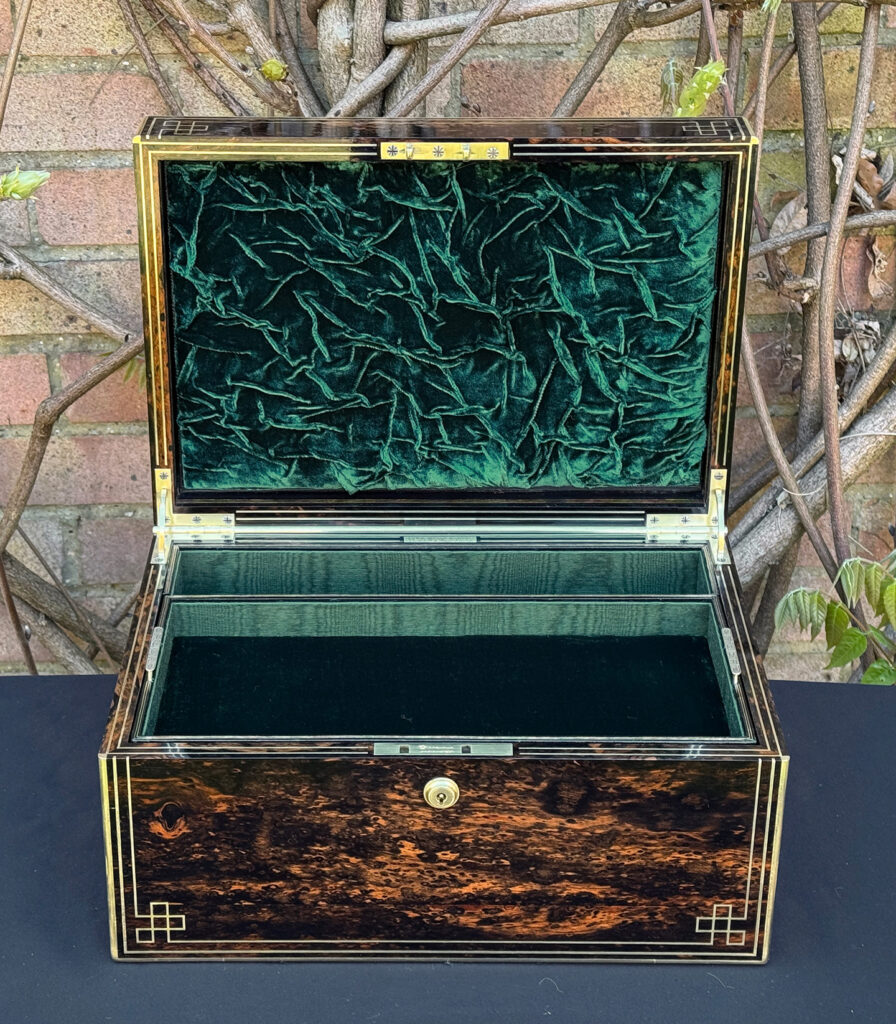 Front interior view of an antique jewellery box in coromandel, by William Lund.