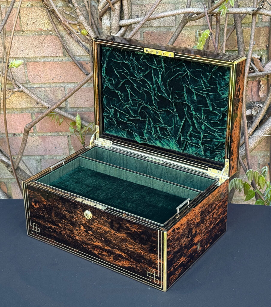 Front right interior view of an antique jewellery box in coromandel, by William Lund.