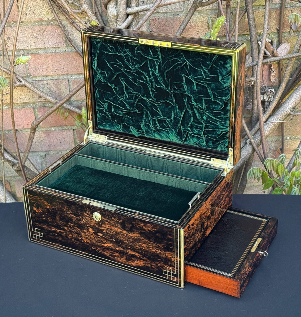 Front right interior view of an antique jewellery box in coromandel, by William Lund, with side drawer open.