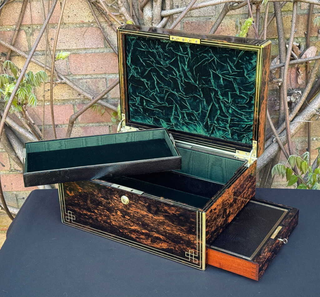 Front right interior view of an antique jewellery box in coromandel, by William Lund, with side drawer open and tray removed.