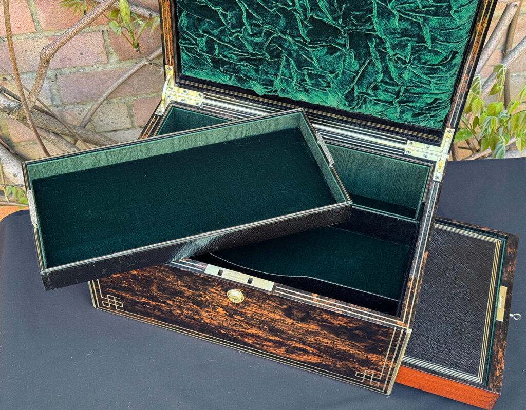 Closer interior view of an antique jewellery box in coromandel, by William Lund, with side drawer open and tray removed.