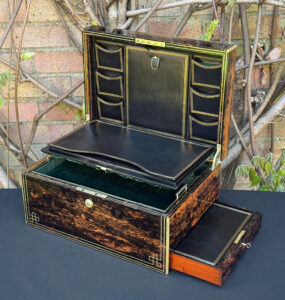 Front right interior view of an antique jewellery box in coromandel, by William Lund, with letter and stamp wallets on view.