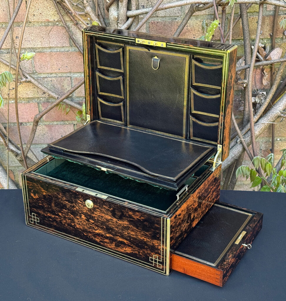 Front right interior view of an antique jewellery box in coromandel, by William Lund, with letter and stamp wallets on view.