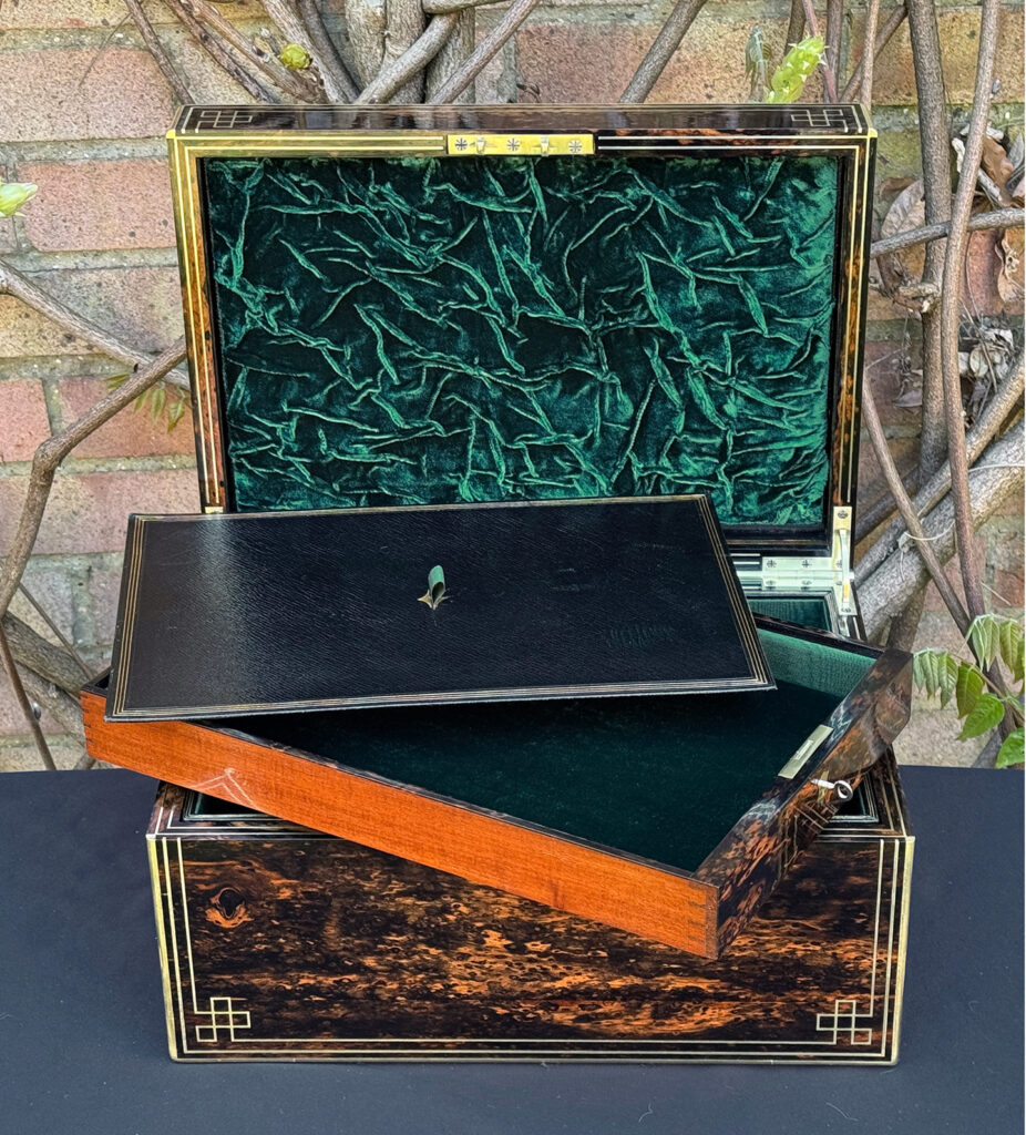 Front interior view of an antique jewellery box in coromandel, by William Lund, with removed side drawer and writing surface on display.