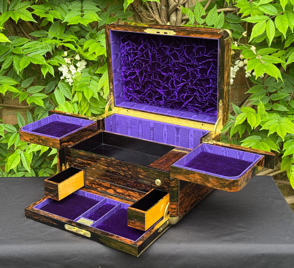 Front right interior view of an extra large antique jewellery box in coromandel with Betjemann Patent 'automatic' mechanism, by Leuchars, with two drawers opened.