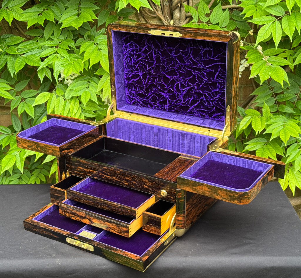 Front right interior view of an extra large antique jewellery box in coromandel with Betjemann Patent 'automatic' mechanism, by Leuchars, with four drawers opened.