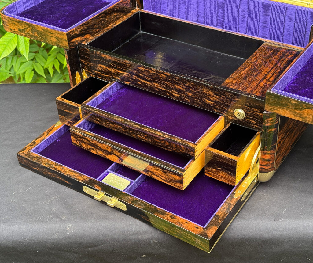 Closer interior view of an extra large antique jewellery box in coromandel with Betjemann Patent 'automatic' mechanism, by Leuchars, with four drawers opened.
