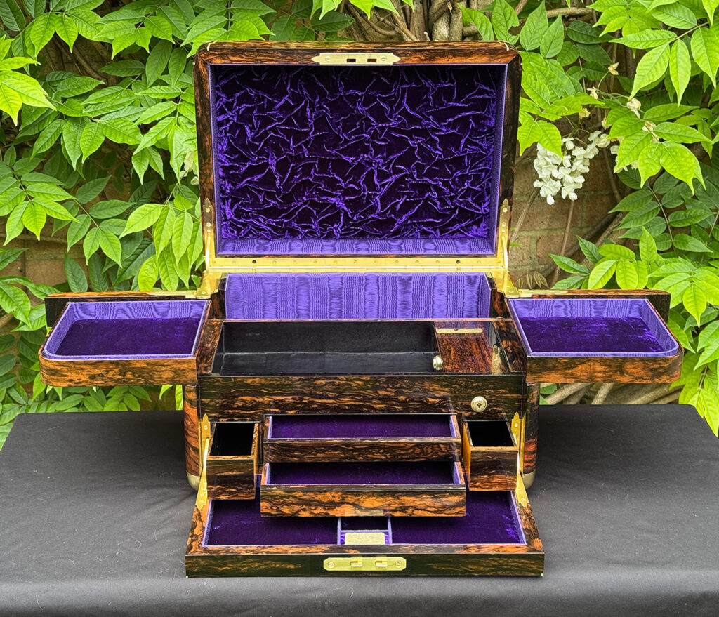 Front interior view of an extra large antique jewellery box in coromandel with Betjemann Patent 'automatic' mechanism, by Leuchars, with four drawers opened.