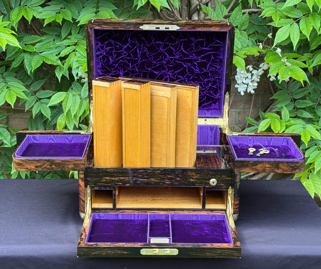 Front interior view of an extra large antique jewellery box in coromandel with Betjemann Patent 'automatic' mechanism, by Leuchars, with all four satinwood drawers removed.