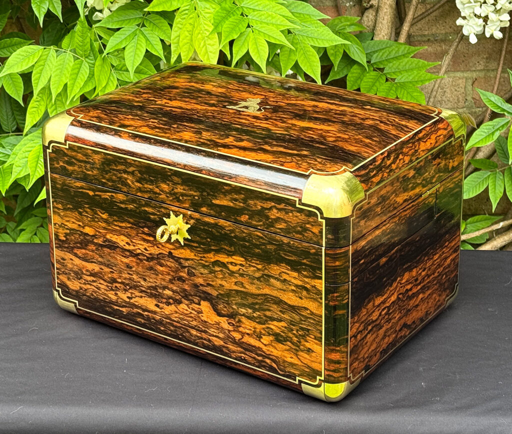 Front right view of an extra large antique jewellery box in coromandel with Betjemann Patent 'automatic' mechanism, by Leuchars, with key inserted.