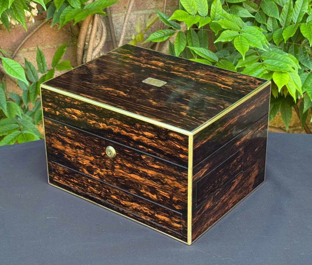 Front right view of an antique jewellery box in coromandel with front & side drawer.