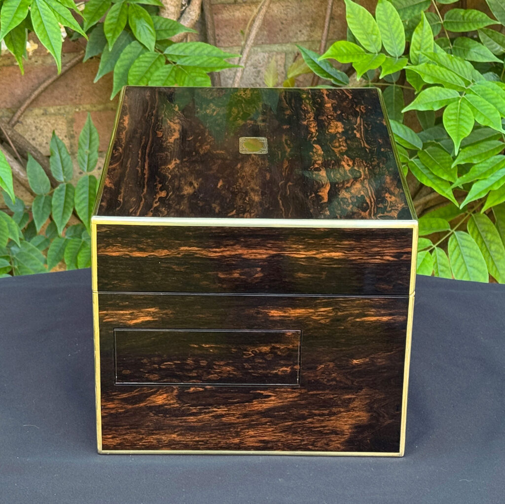 Right side view of an antique jewellery box in coromandel with front & side drawer.
