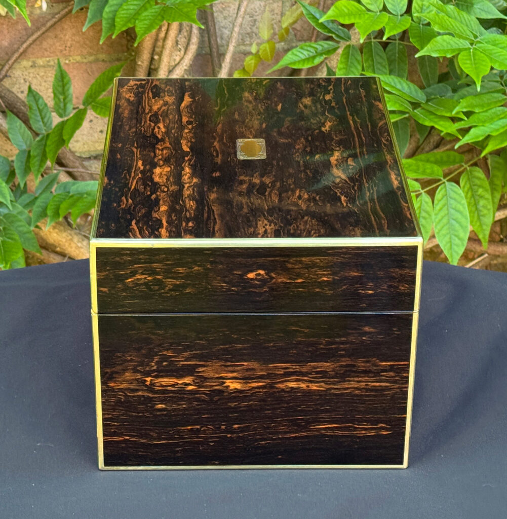 Left side view of an antique jewellery box in coromandel with front & side drawer.