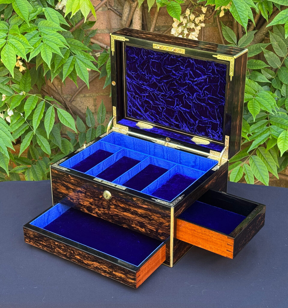 Front right interior view of an antique jewellery box in coromandel with front & side drawer, with both drawers opened.