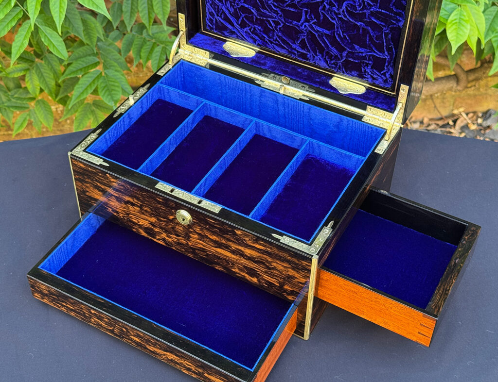 Closer interior view of an antique jewellery box in coromandel with front & side drawer, with both drawers opened.
